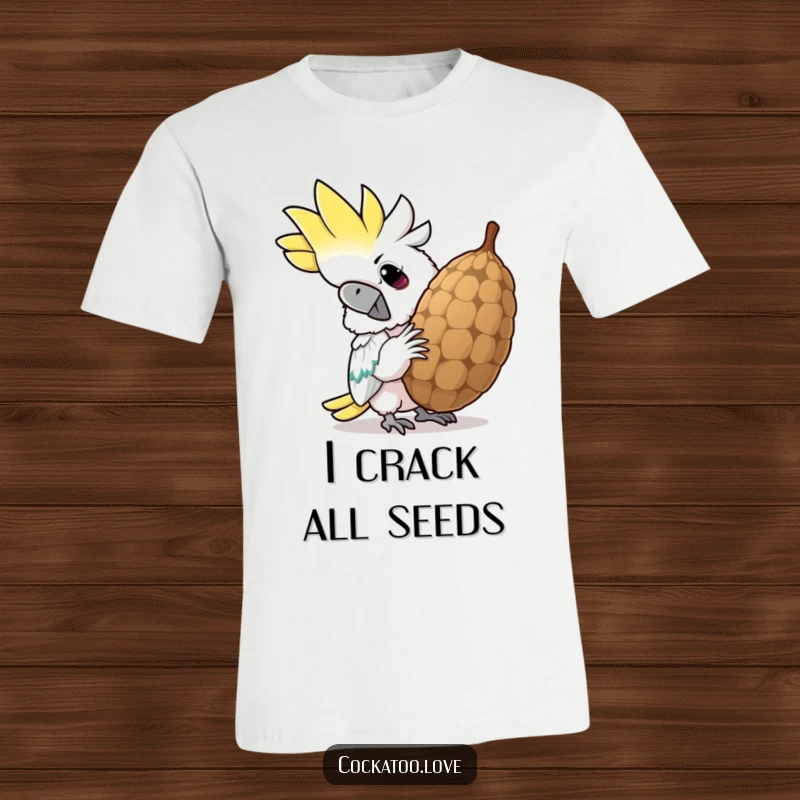 Funny cockatoo t-shirt, shown cracking a giant seed with a determined grin, perfect for bird lovers and humor enthusiasts.